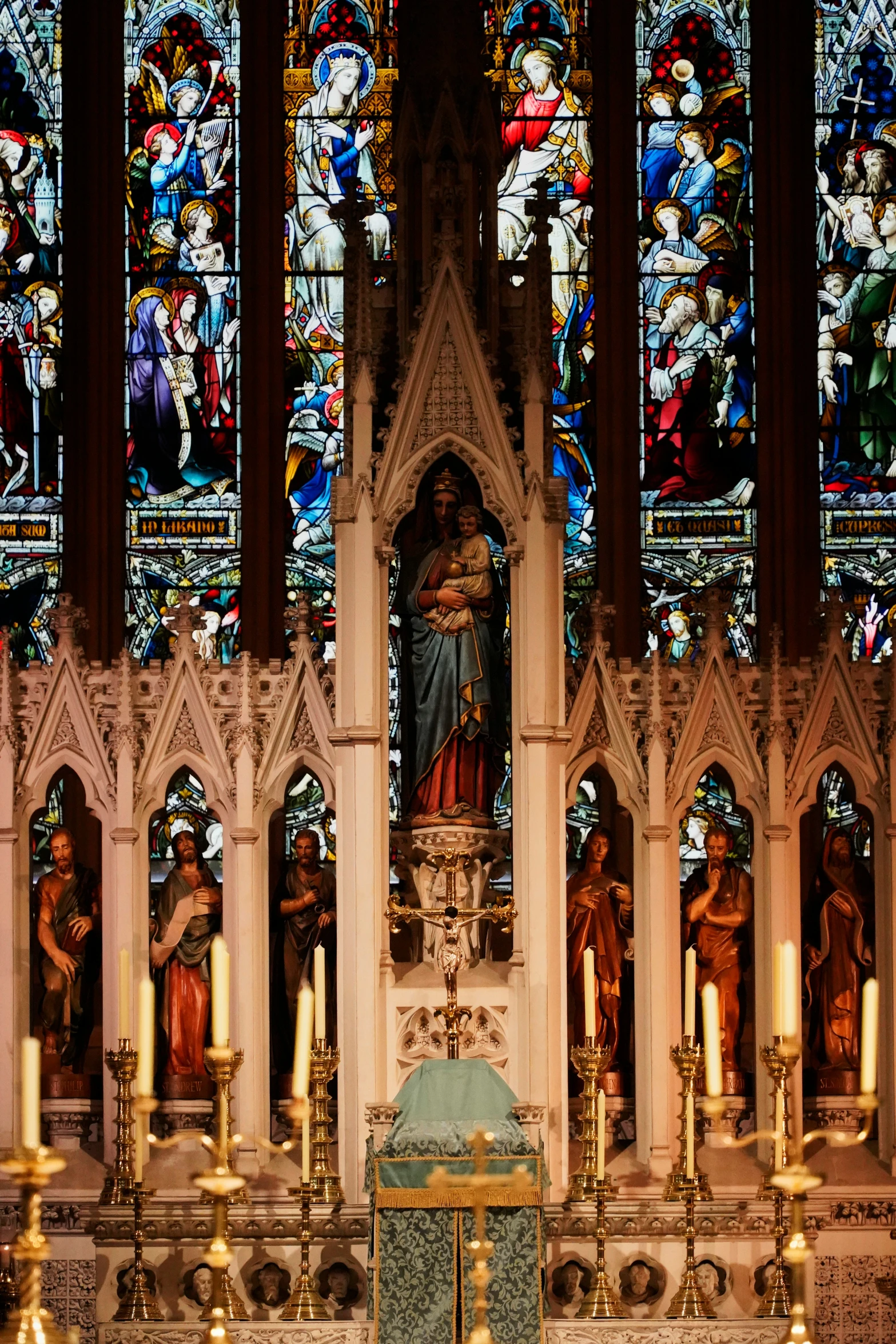 a large stained glass window behind a pew