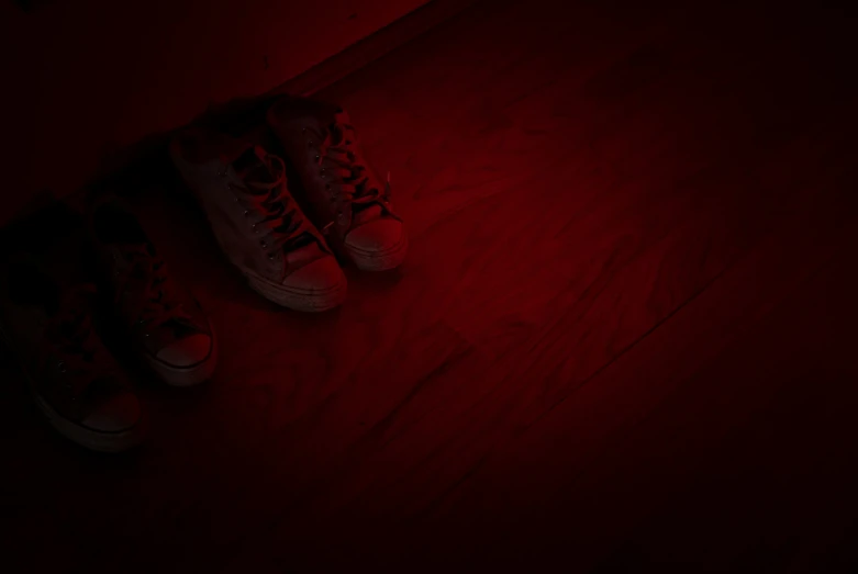 red sneakers and dark flooring in a room