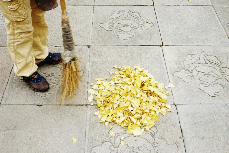 a person has a broom that looks like soing out of trash