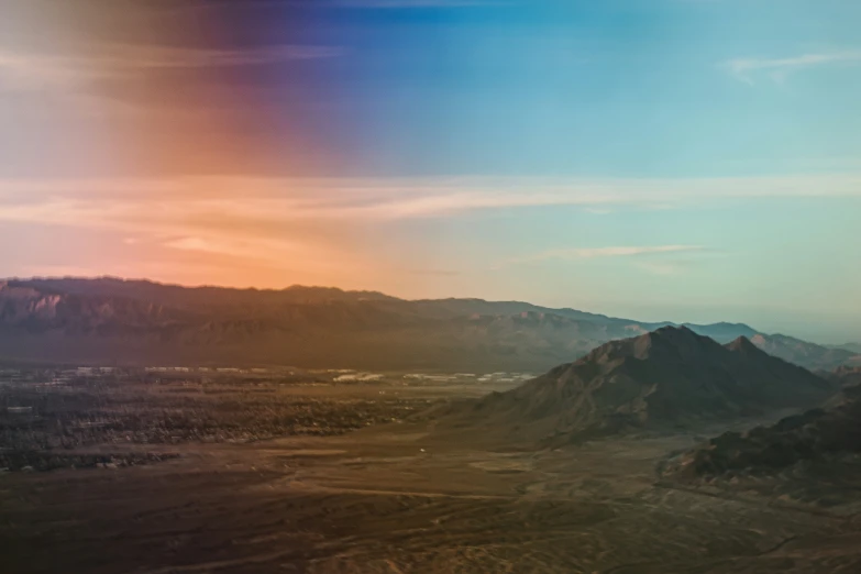 a view from an airplane of mountains and sky