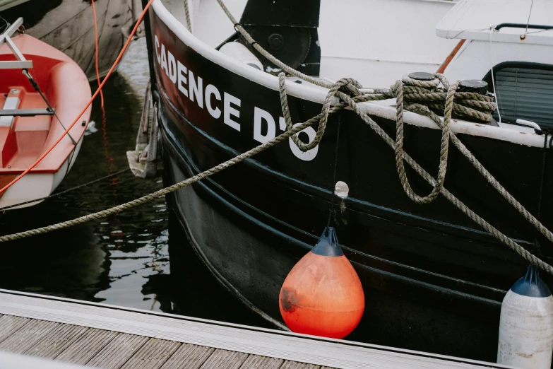 a boat with two buoys tied up next to it