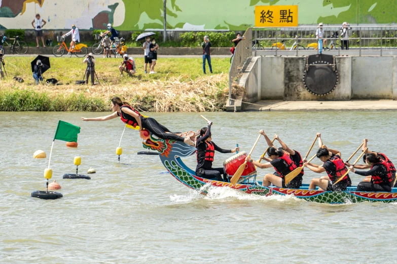 several people are rowing small boats on a river