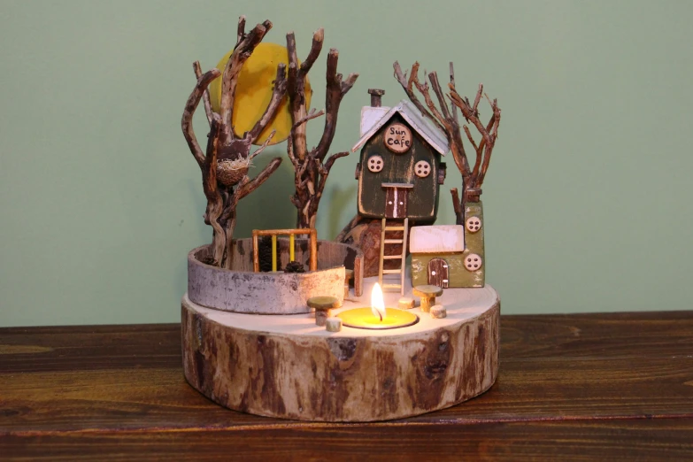 a candle is lit in front of a tree trunk stand