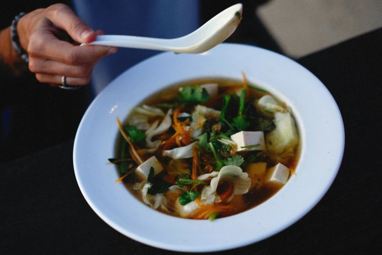 a bowl of soup is being served with a spoon