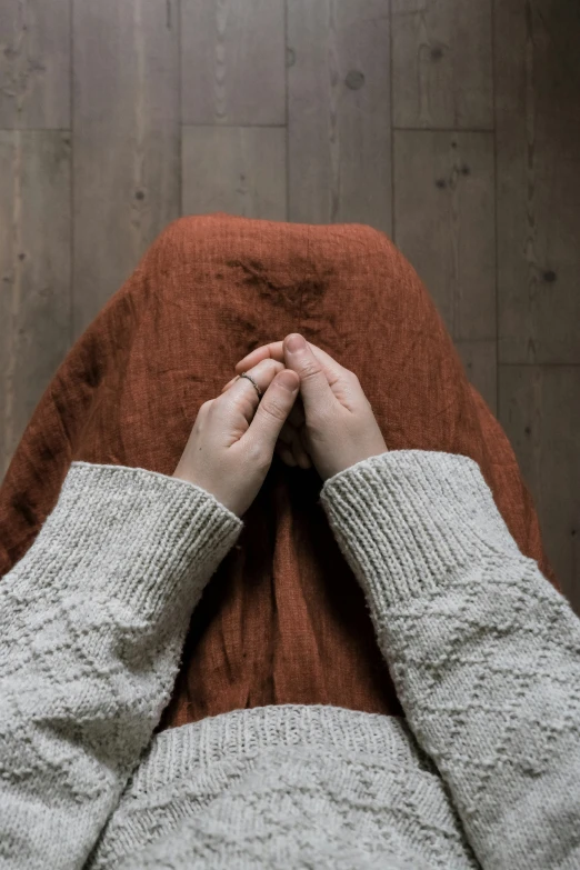 a person with their hands over the top of their head