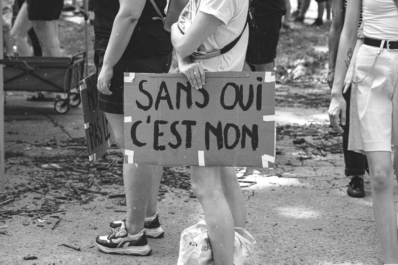 a sign reads sans ou c'est don on a man in shorts