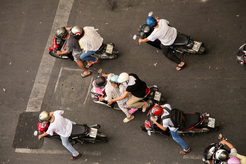 people hing carts down the road on a city street