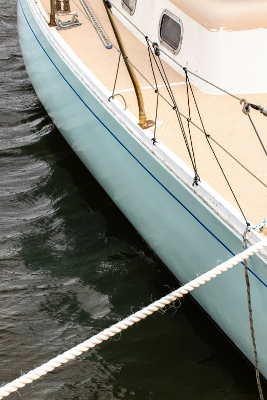 the mast of a large boat docked on the water