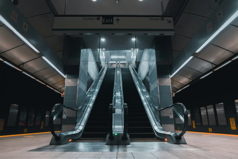 an escalator in the middle of a building next to another