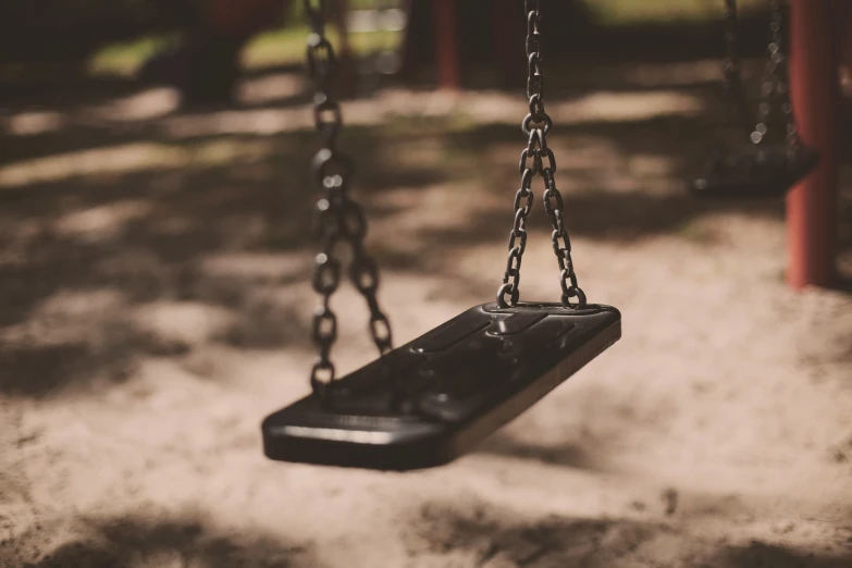 a remote control is hanging from a chain in a park