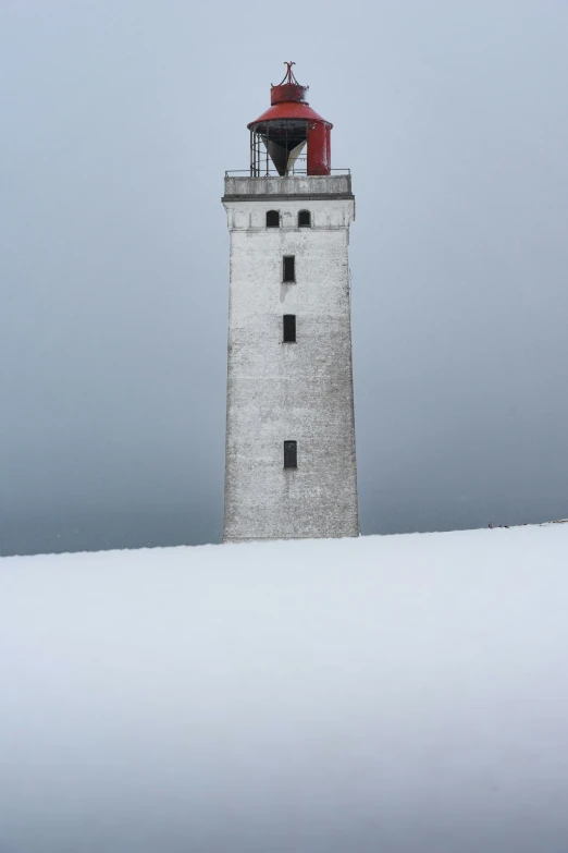 a tall white tower that has a red roof