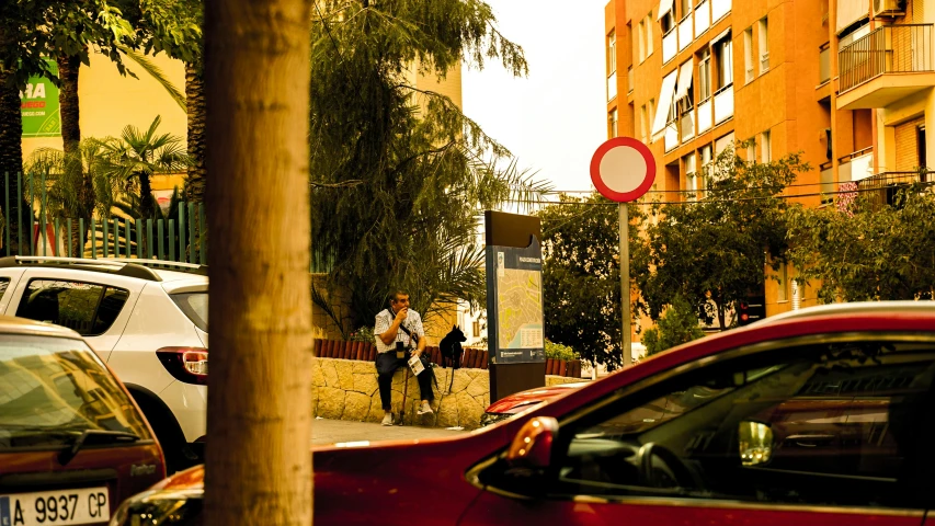 a group of people sitting outside on the sidewalk