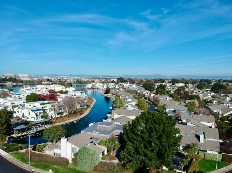 the view of an area along a river, including houses and homes