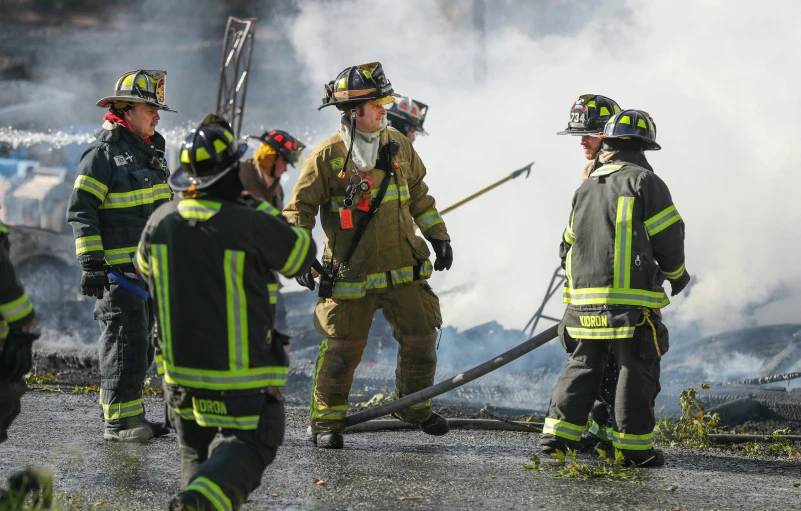 some firemen in uniform and smoking smoke