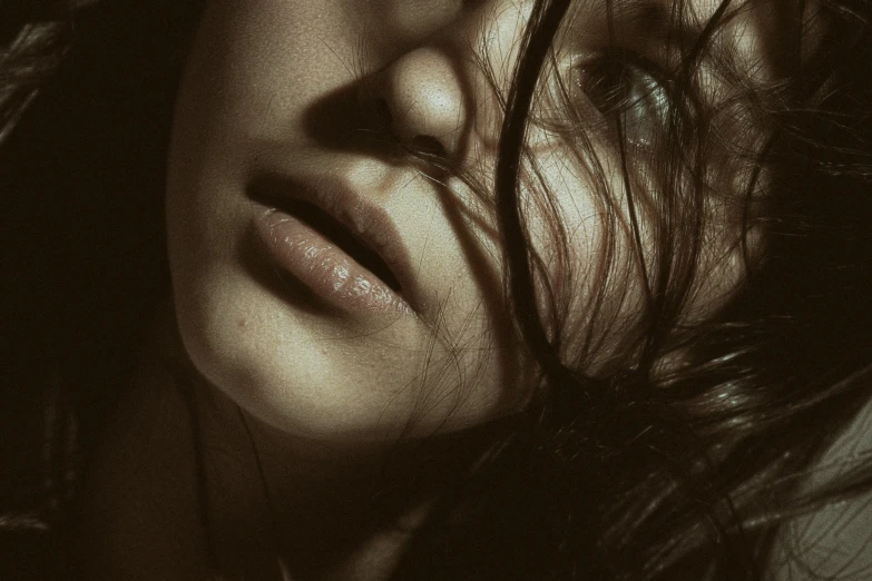 woman with curly hair and dark eyes posing for camera