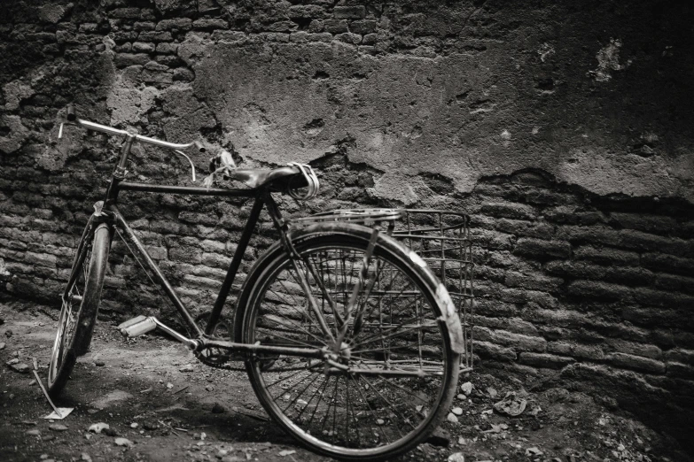 a vintage bicycle leans against a wall
