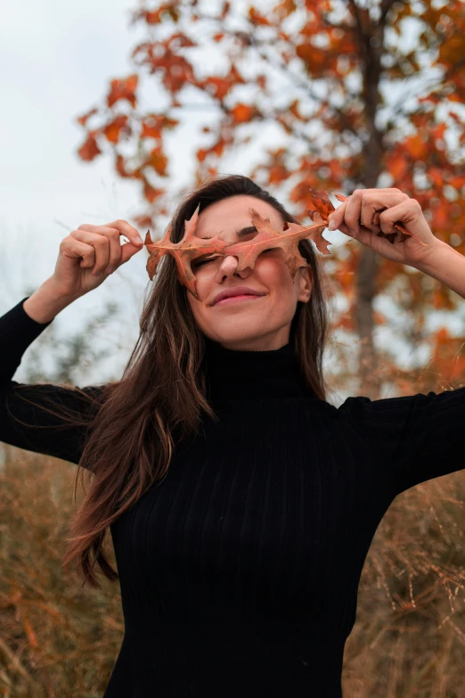 a woman holds up the sides of her eyes