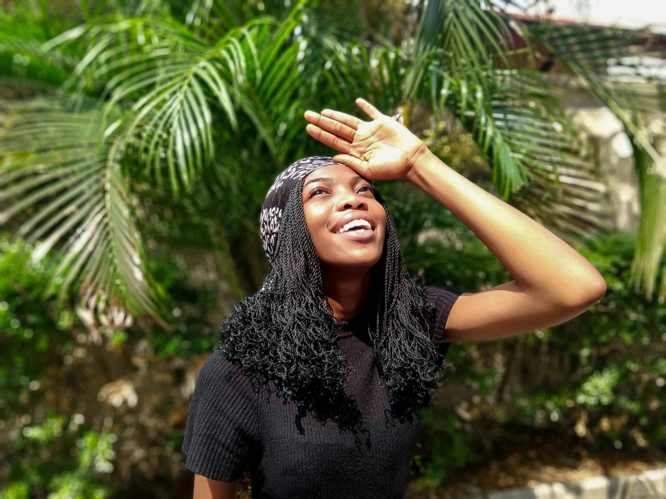 an african american woman is raising her hand