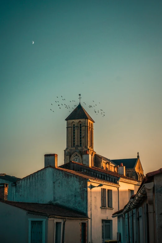 a tower clock sits on the top of a building