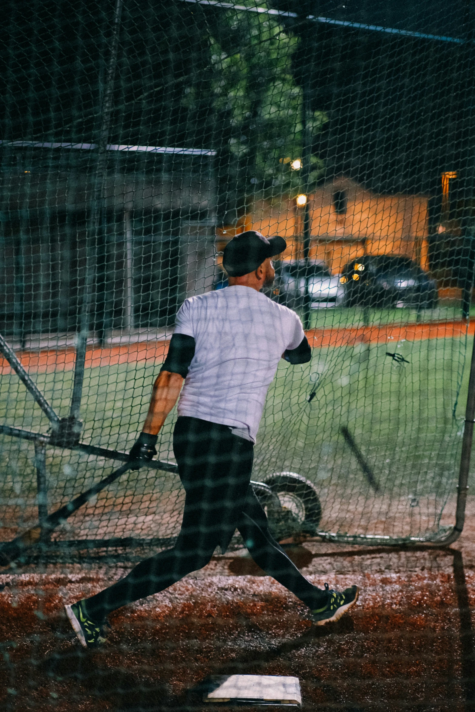 there is a person playing baseball outside at night