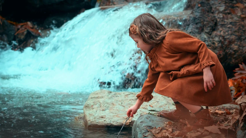 a  kneeling down while playing in water