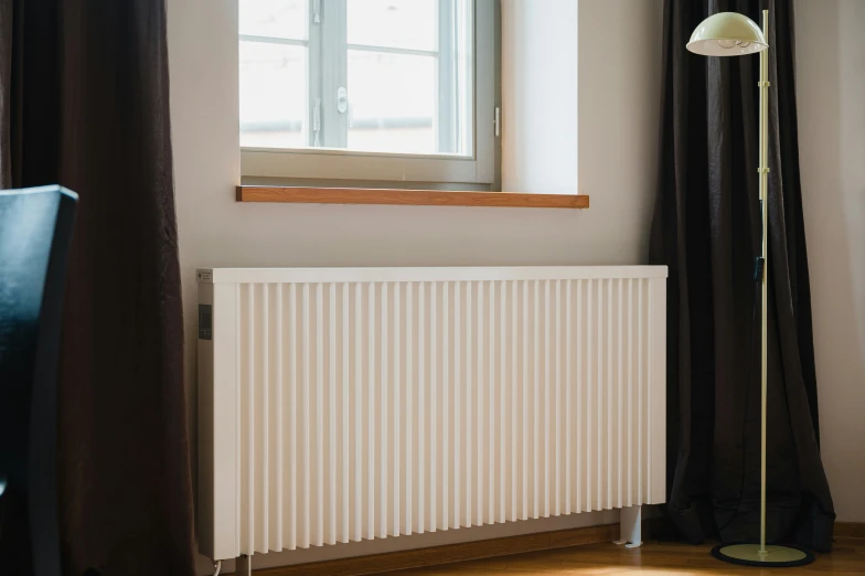 a white radiator sitting in front of a window