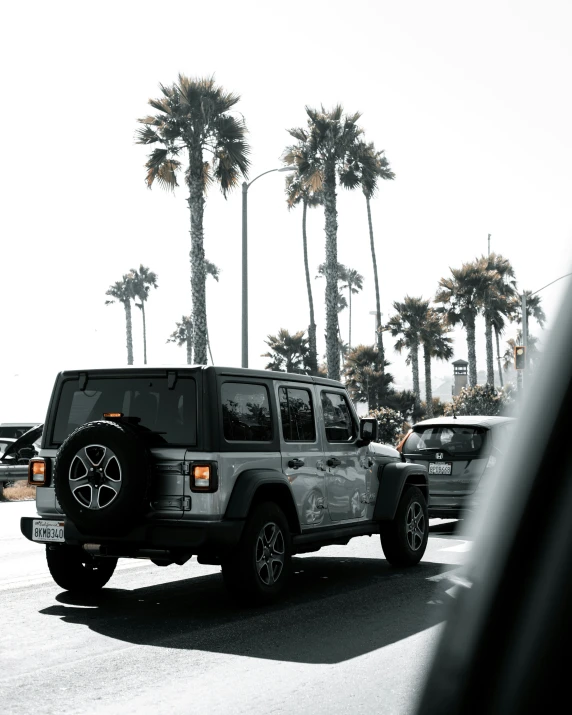 a black jeep parked in front of a building near trees