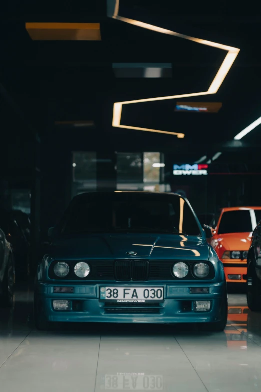 some cars are parked in a dimly lit building