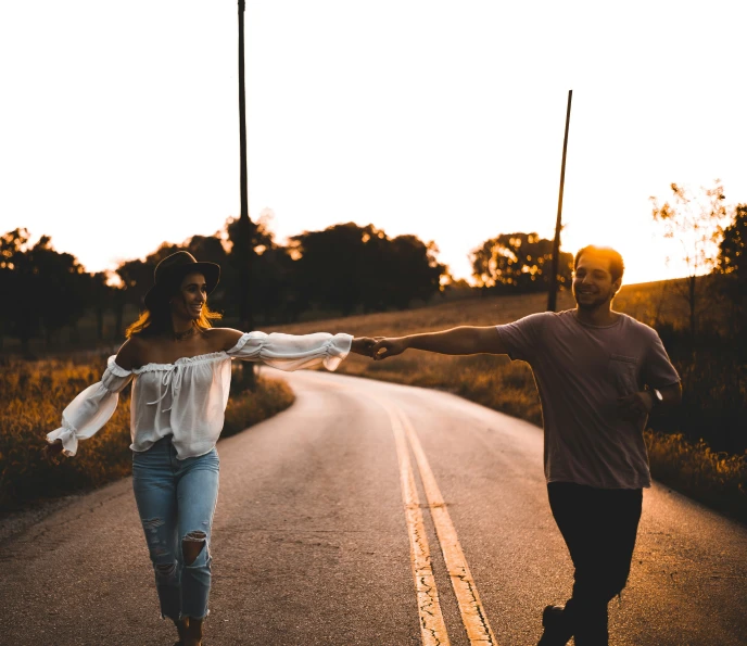 a couple walking down the road holding hands