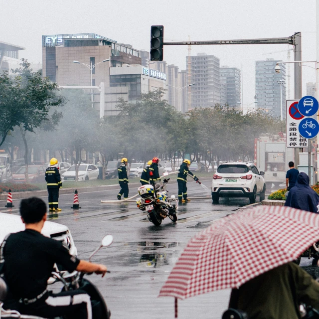 some people are on motorcycles and cars are in the street