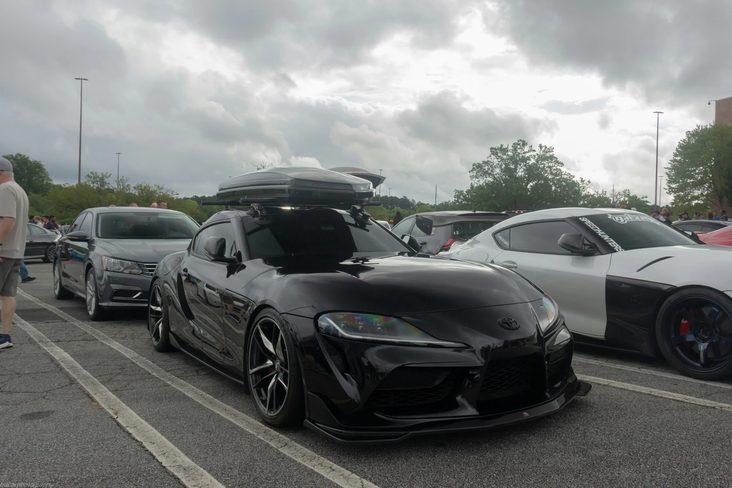 two cars parked next to each other in a parking lot