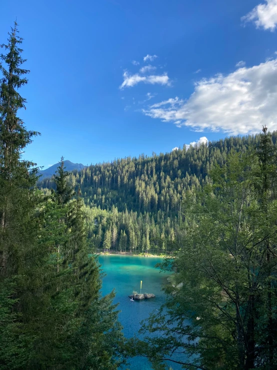 people paddle a boat in the clear blue lake