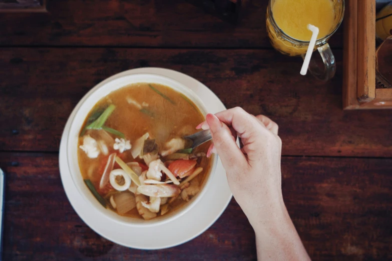 a bowl of food with noodles, carrots and celery