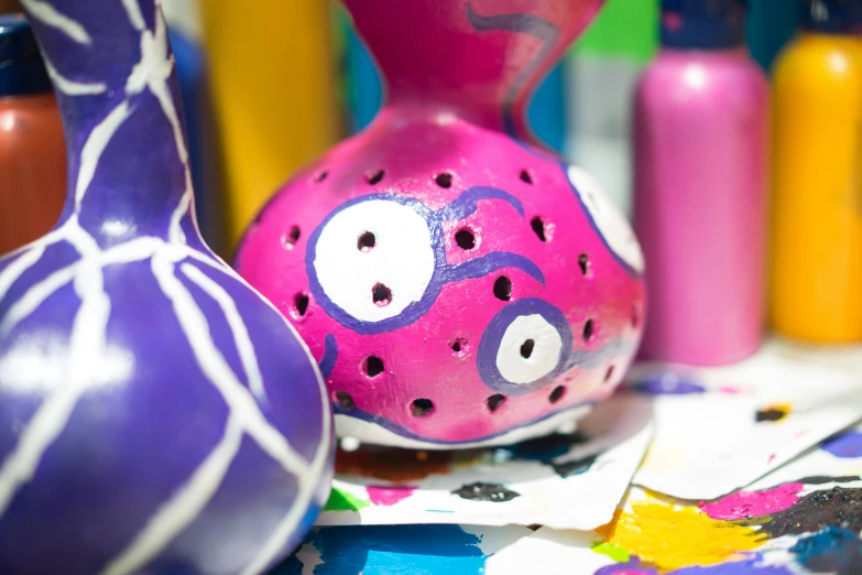 a colorful group of vases on paper on table