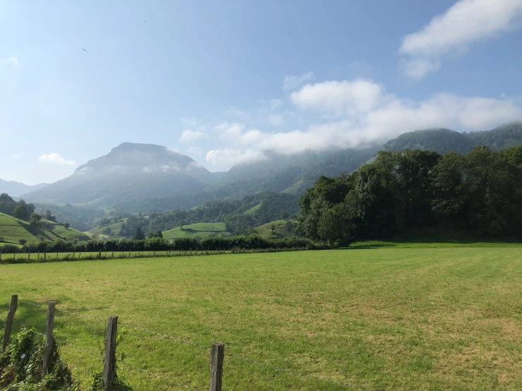 a pasture with mountains in the distance