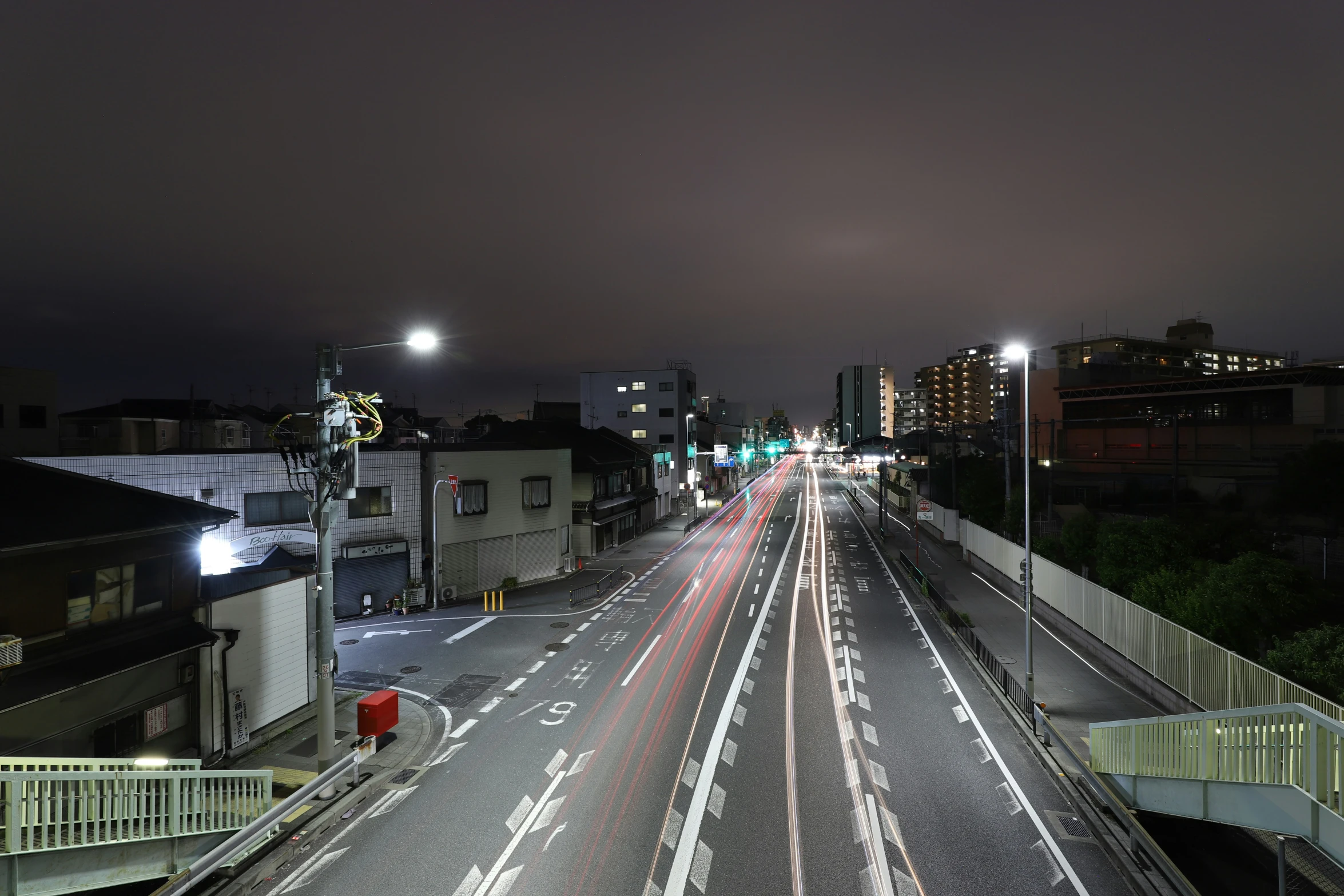 a city street at night time with long lines of traffic