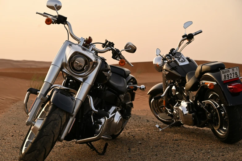 two motor bikes are parked in the desert