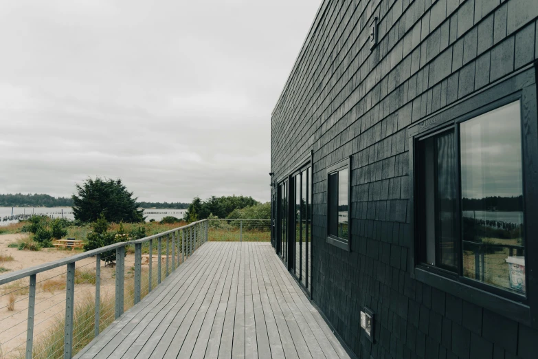 a boardwalk and windows with the ocean in the background