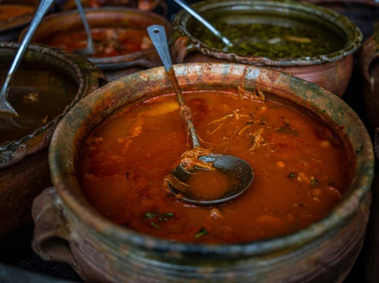 bowls with soup and a spoon in one