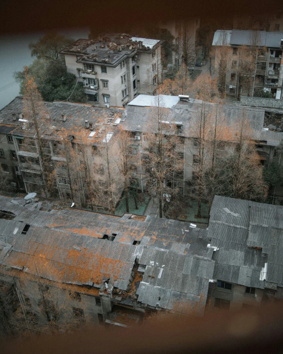 a aerial view of a city with rooftops in autumn