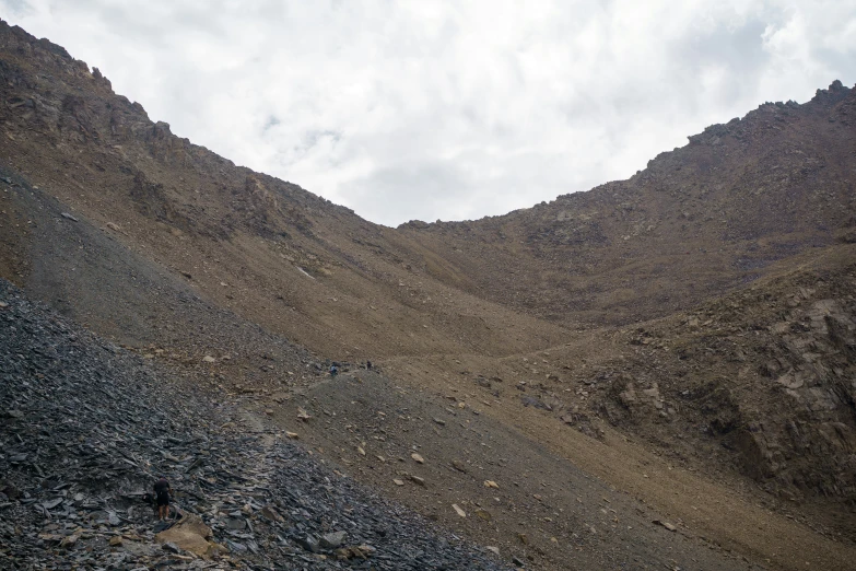 a black and white train some rocks a mountain