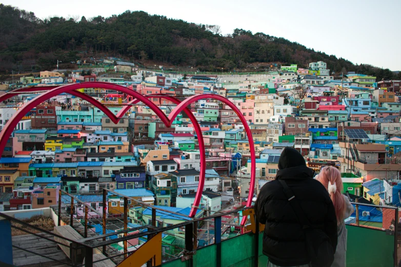 a man at the top of a stairway overlooking a city