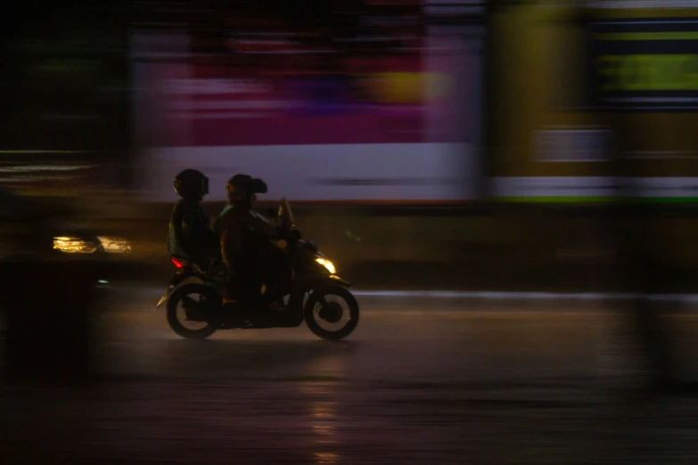 a group of people riding on the back of a motorcycle