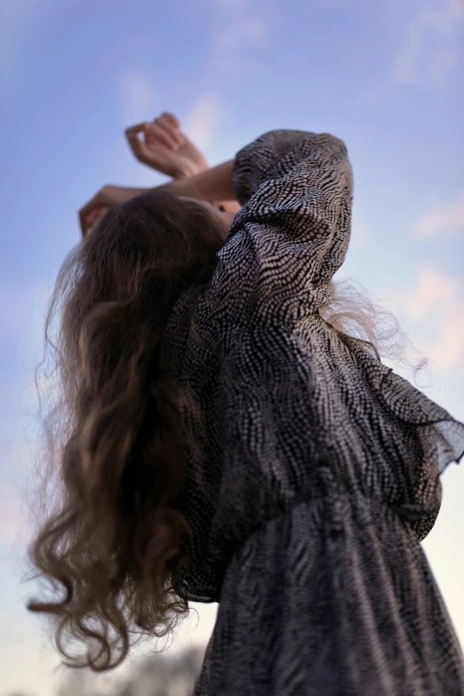 a young woman reaching out into the air