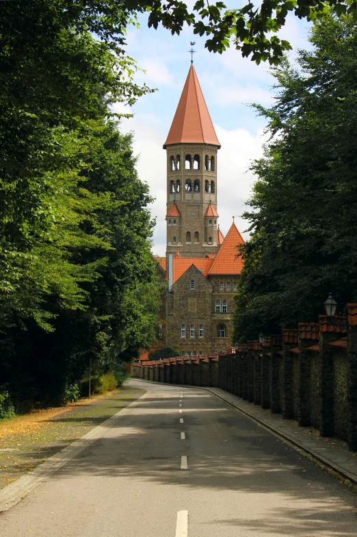 an old stone building sits beside a forest