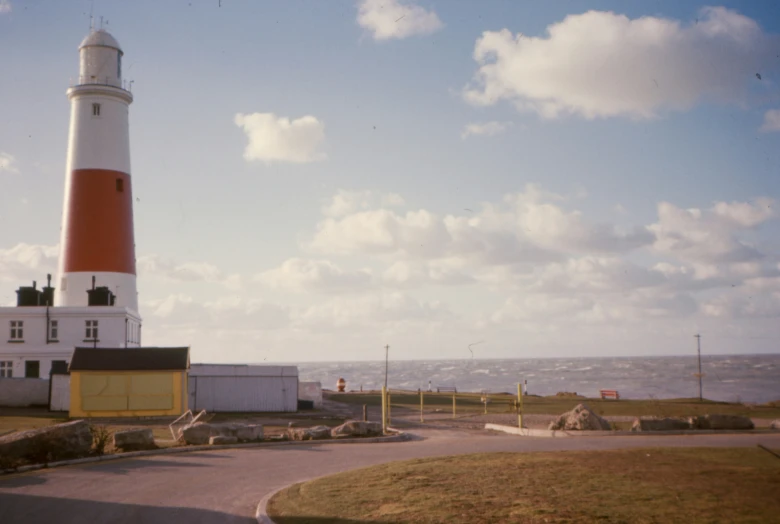 a lighthouse is shown on the shoreline of the ocean