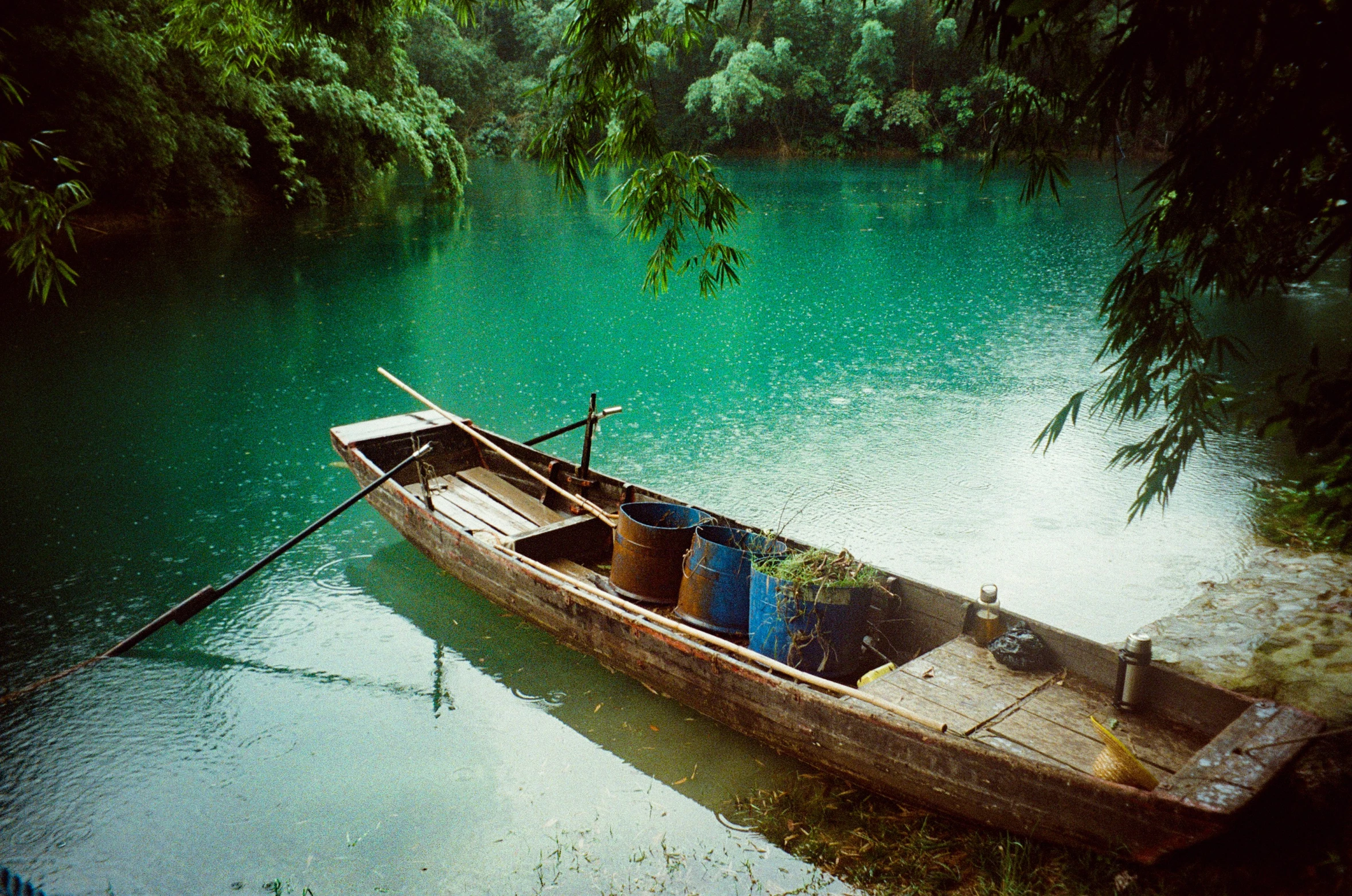 a empty small boat is moored to the shore