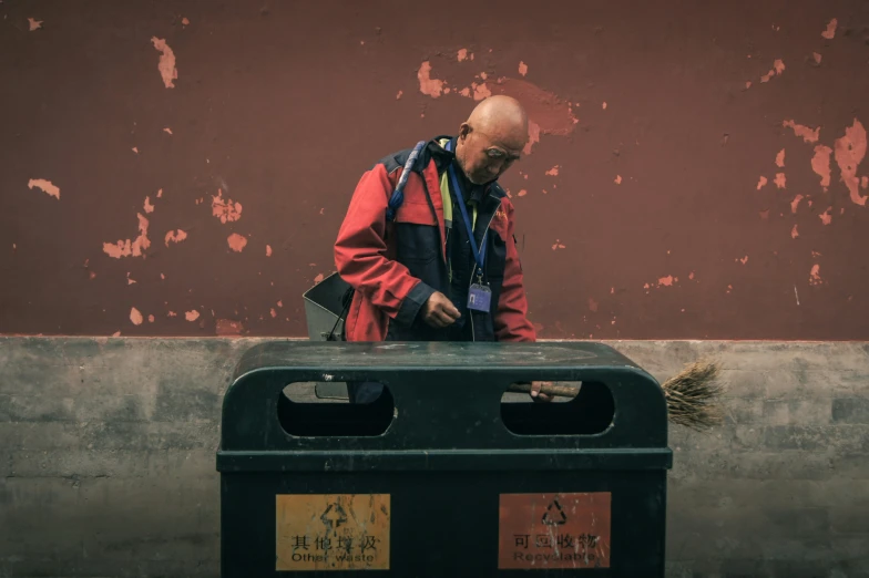 an elderly man walking around an empty container