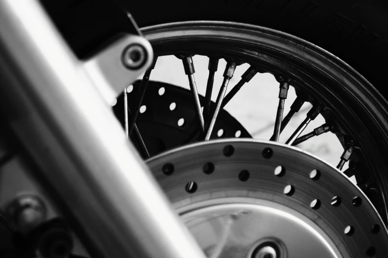 wheel spokes of a motorcycle close up on a metal rod