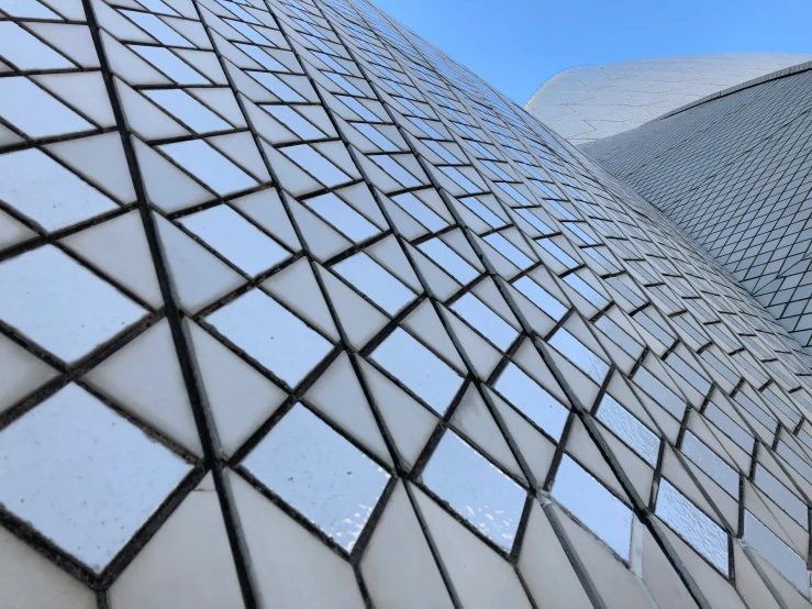 a view looking up at an angled side of a building